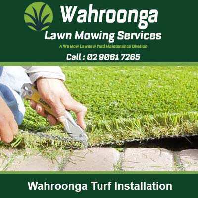Hands using a knife to cut artificial turf in Wahroonga